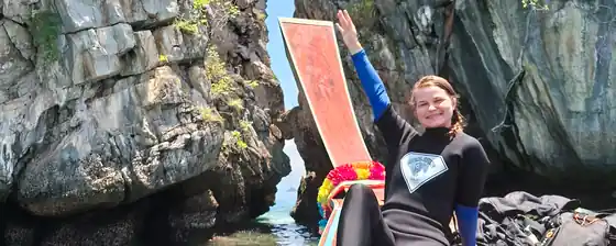 a female diver on a diver boat looking happy